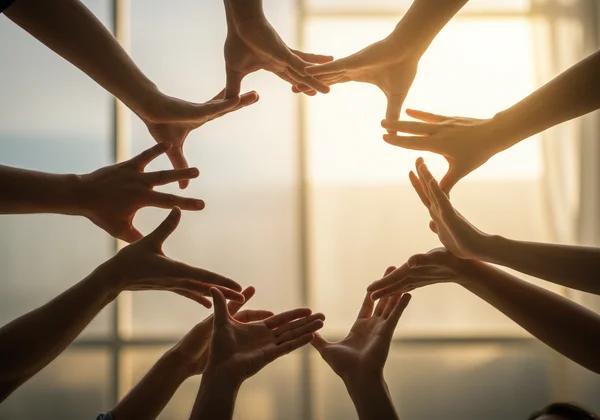 Diverse hands connected, forming a strong support network