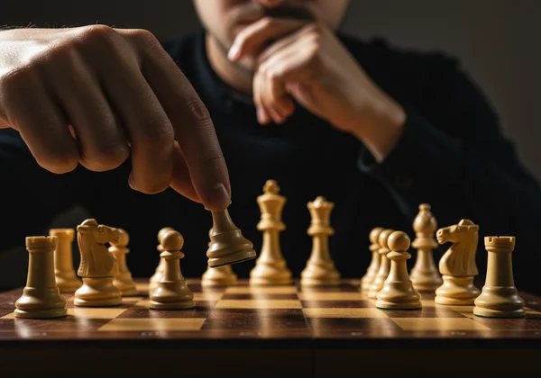 Person playing chess, representing strategic thinking and planning